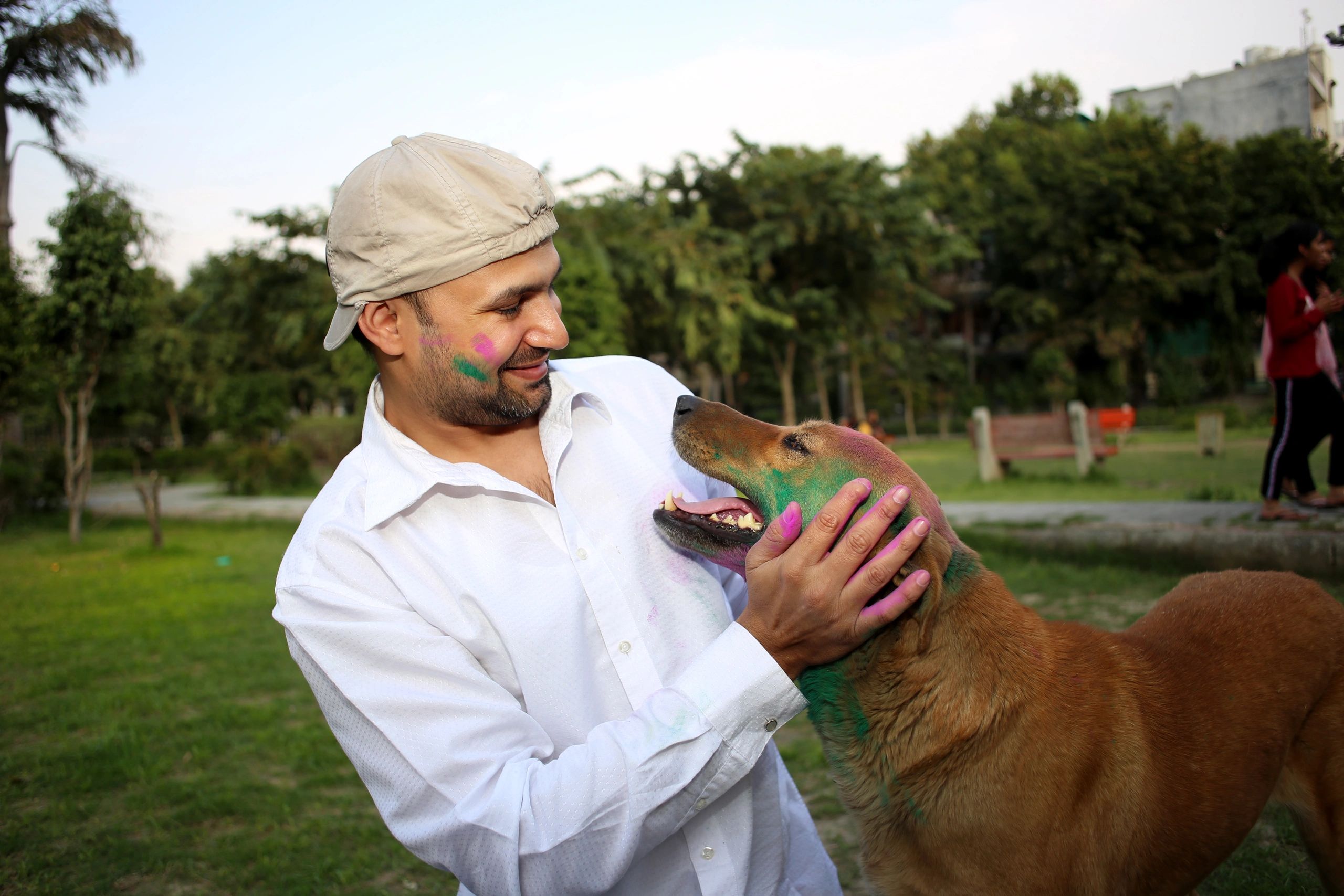 Pet owner with dog outdoors in India