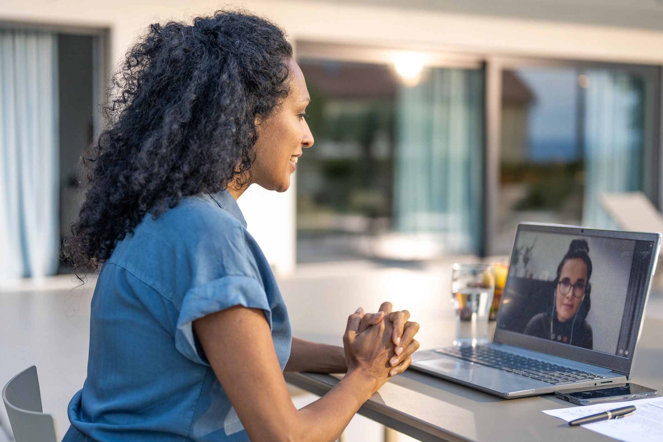 Person attending a video meeting on a laptop