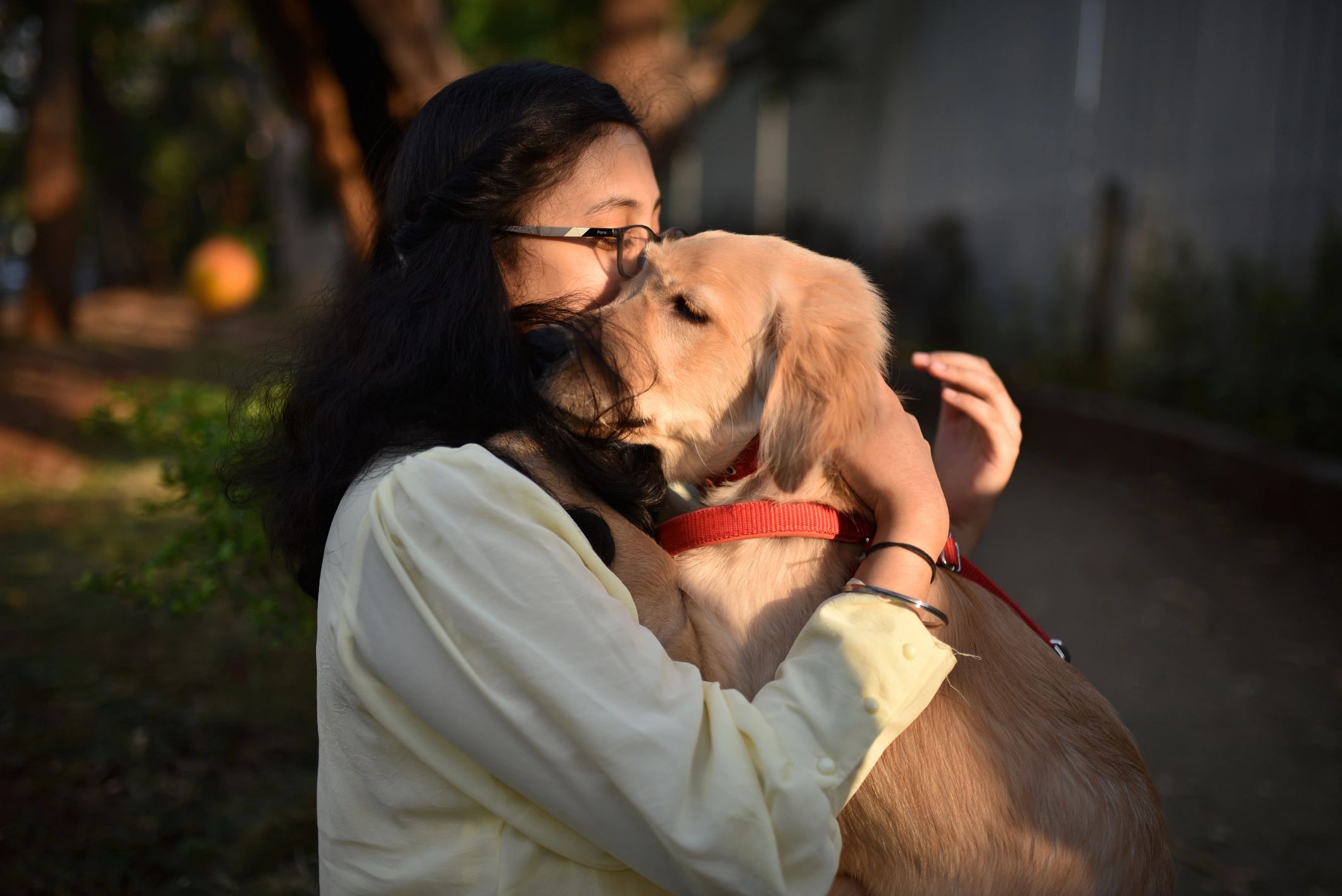 Girl cuddling a pet dog