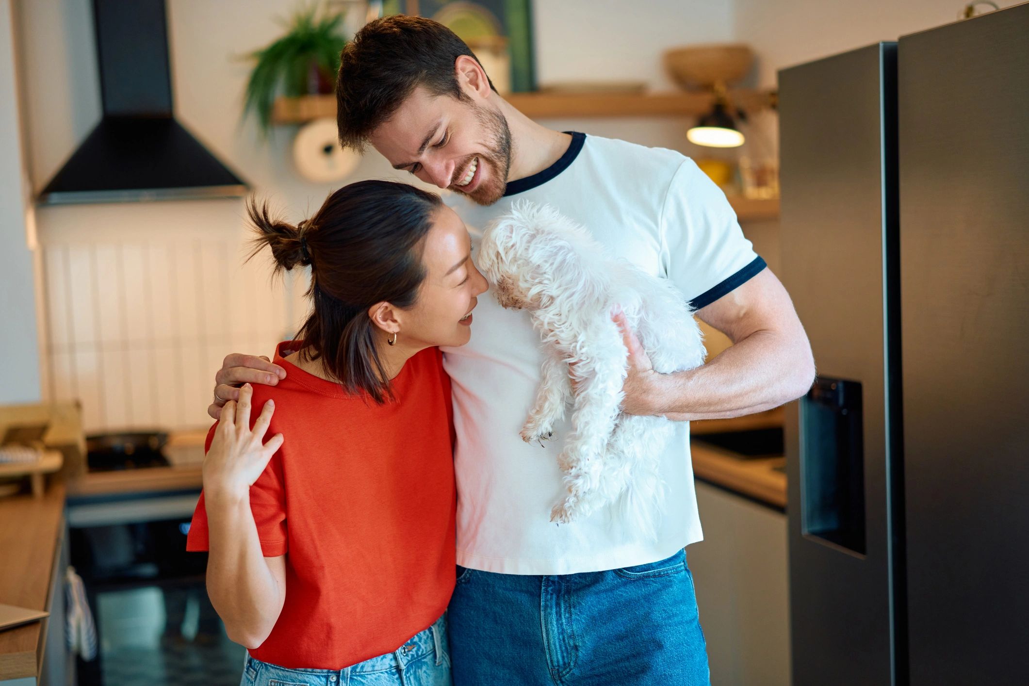 Couple welcoming a small dog into their home